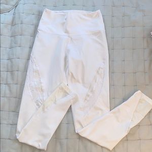white athletic leggings with pattern on thigh